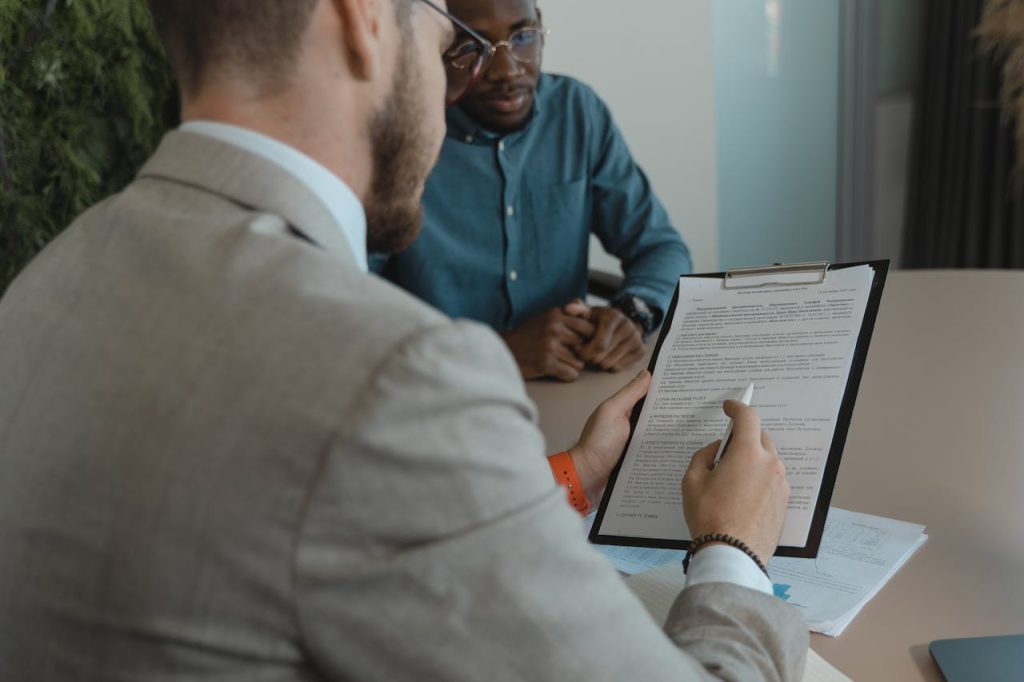 Blog A recruiter reviews a candidates documents during a job interview in a modern office setting.